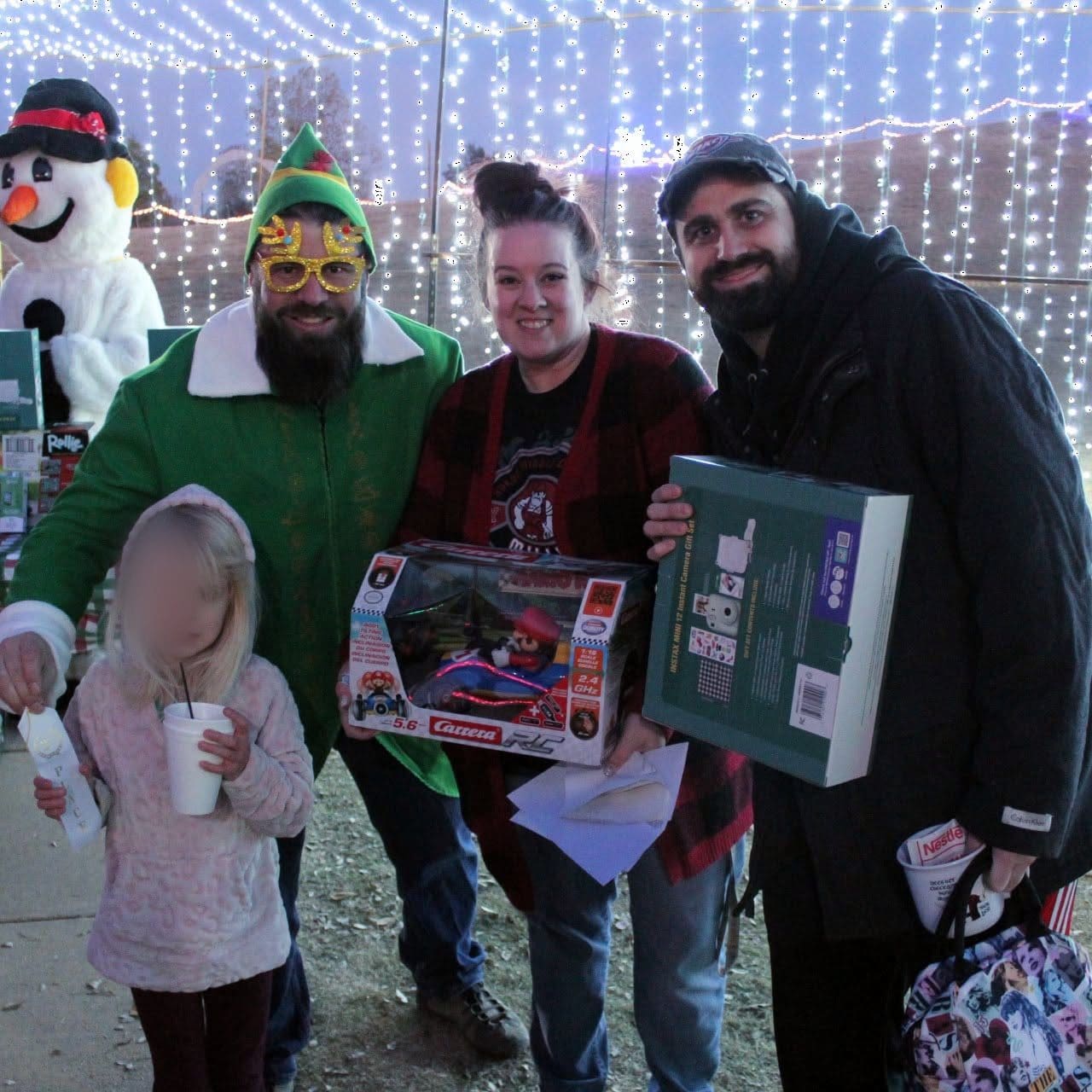 Mayor Brian Pillmore with a Yukon family at the Christmas toy drive