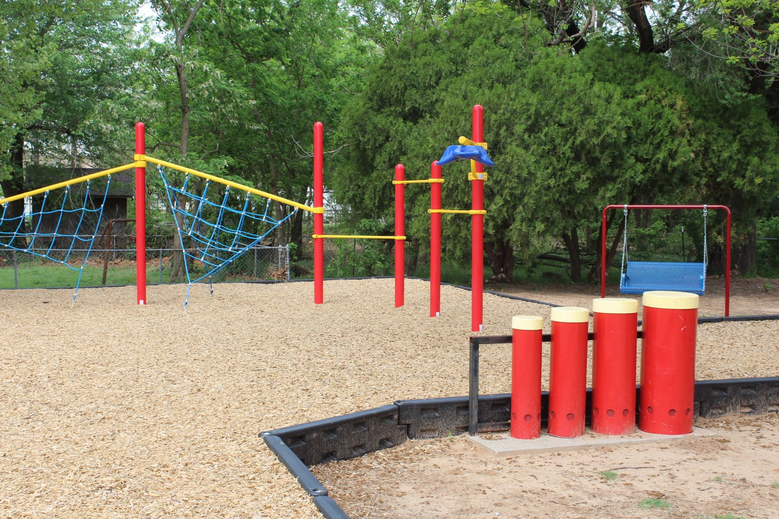 Bledsoe Park playground — swings and seating area