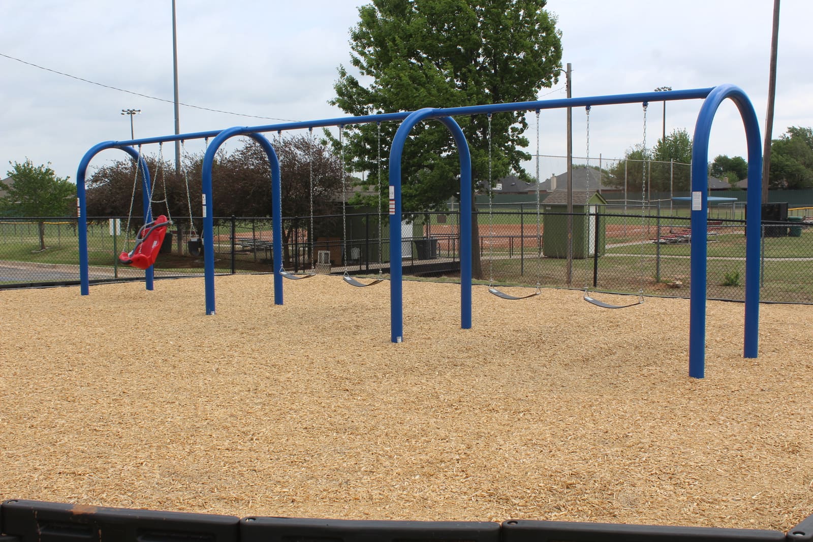 Sunrise Park playground — swings and benches